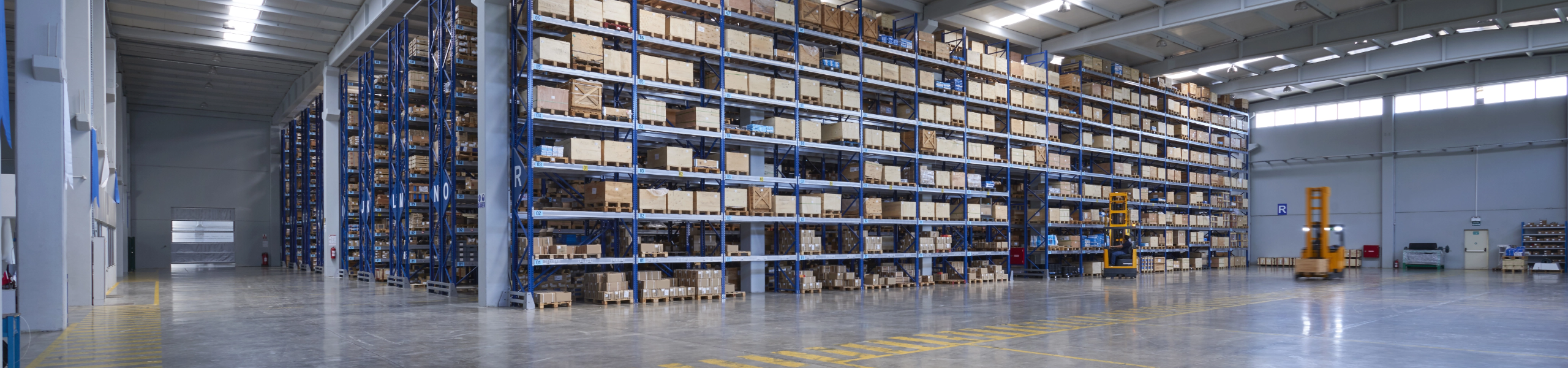 Large warehouse wall with forklift trucks