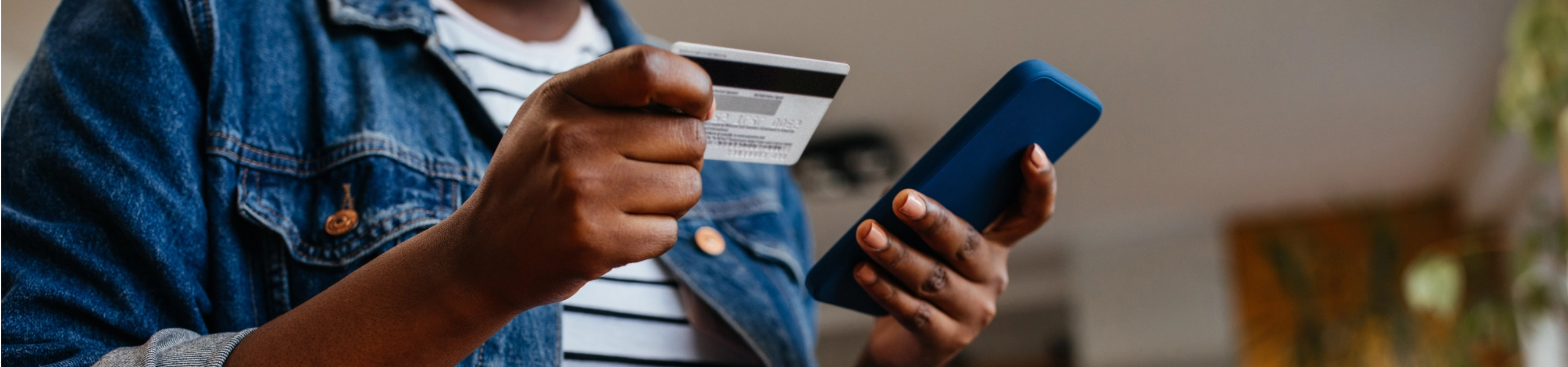 Woman holding phone and credit card